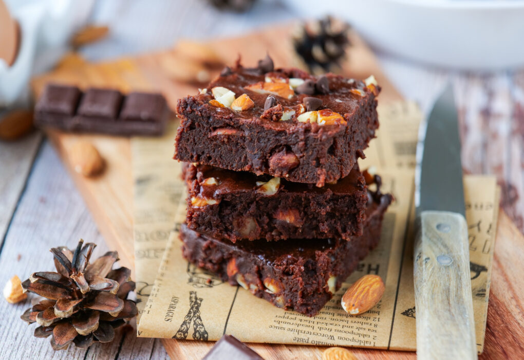Almond chocolate brownies in a baking pan with chocolate chips on top